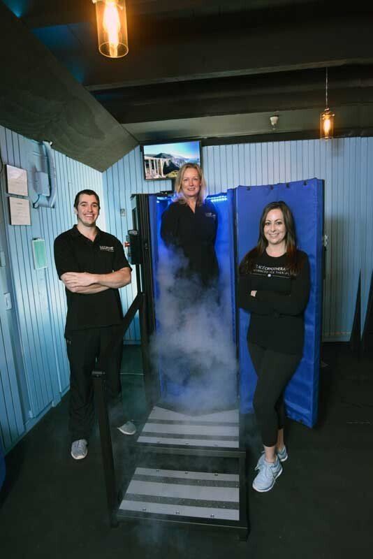 A group of people are standing next to each other in a room.