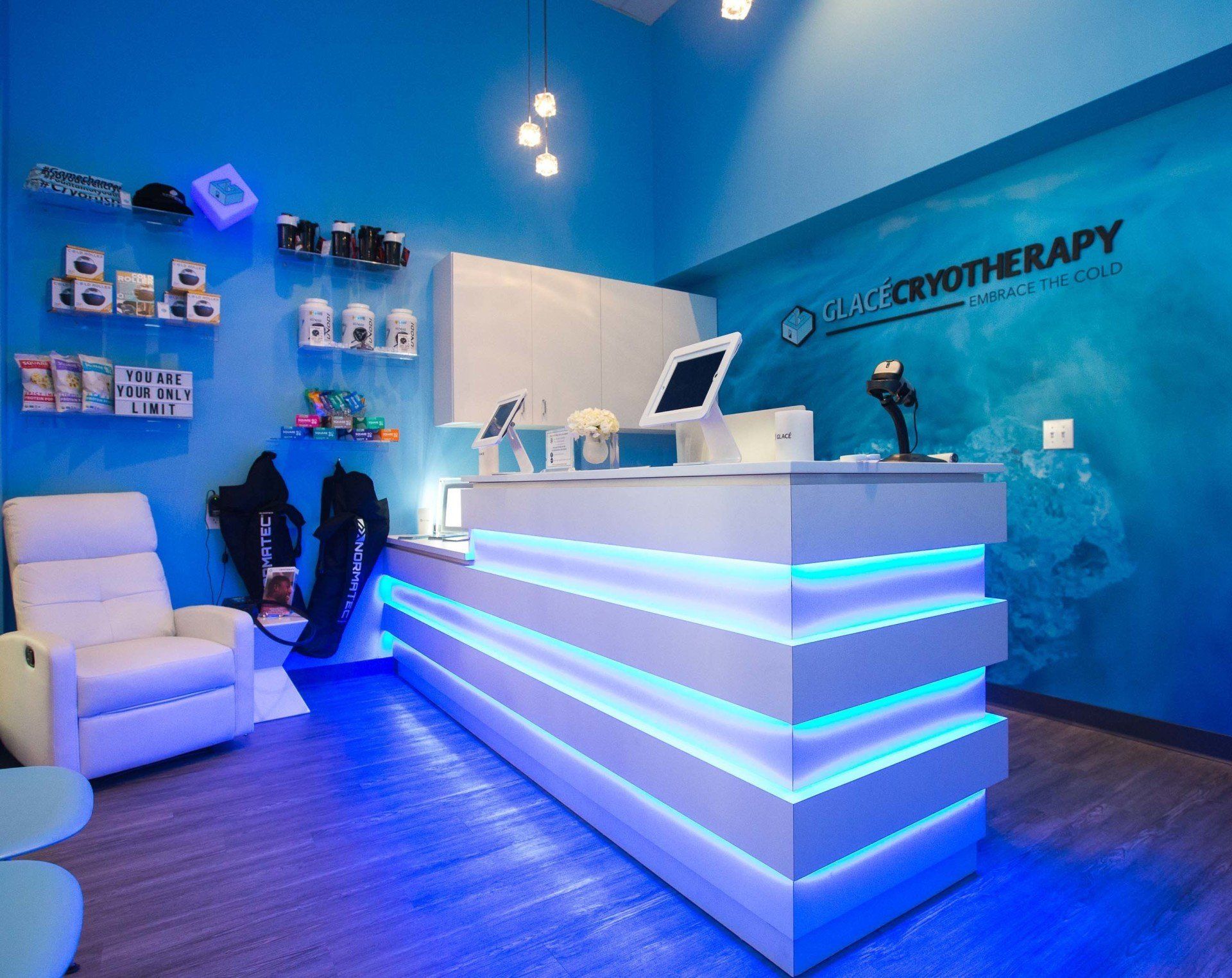 a blue and white room with a white chair and a white counter located inside of a cryo business in the Bay Area of California 
