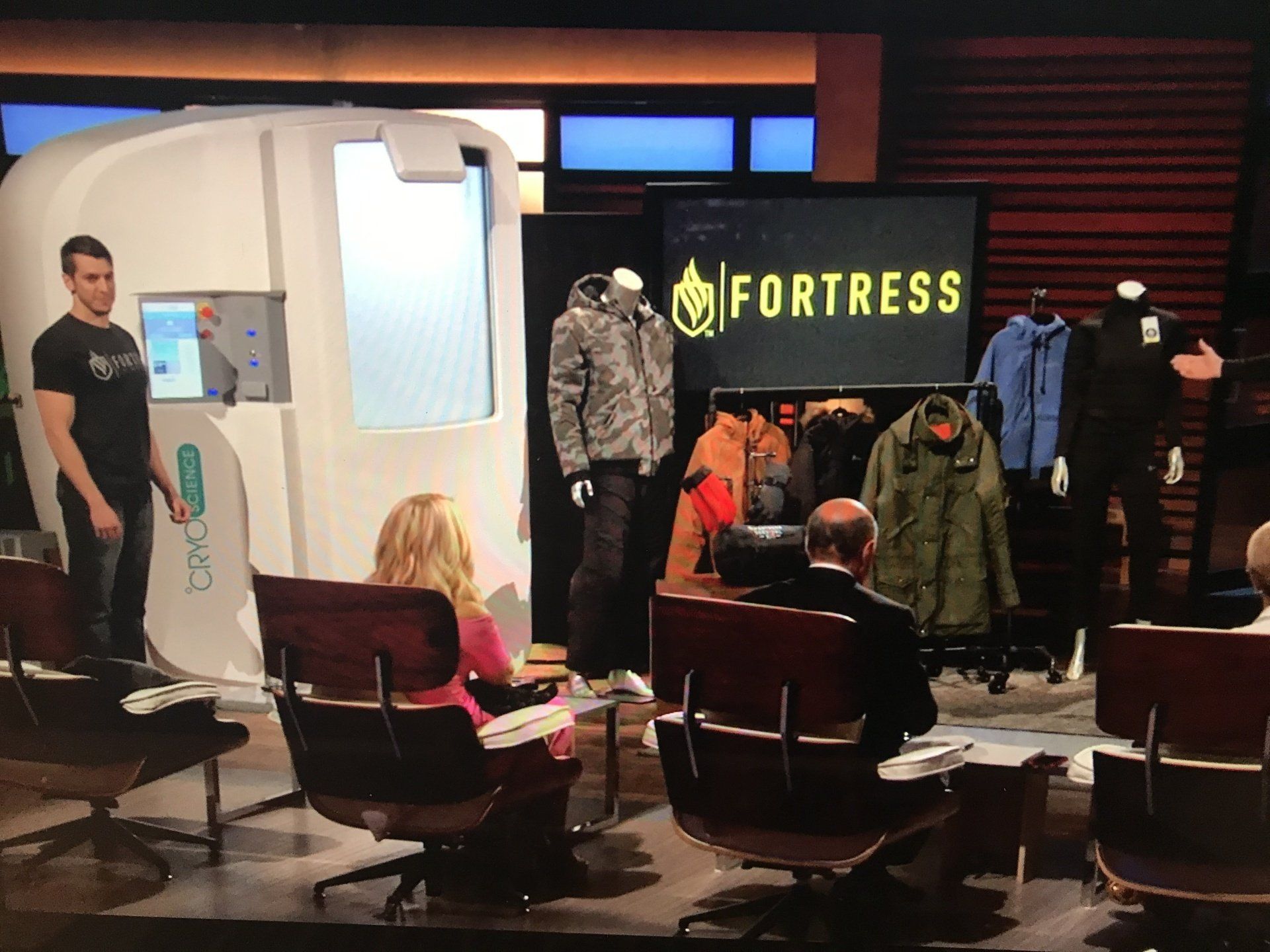 A man stands in front of a screen that says fortress