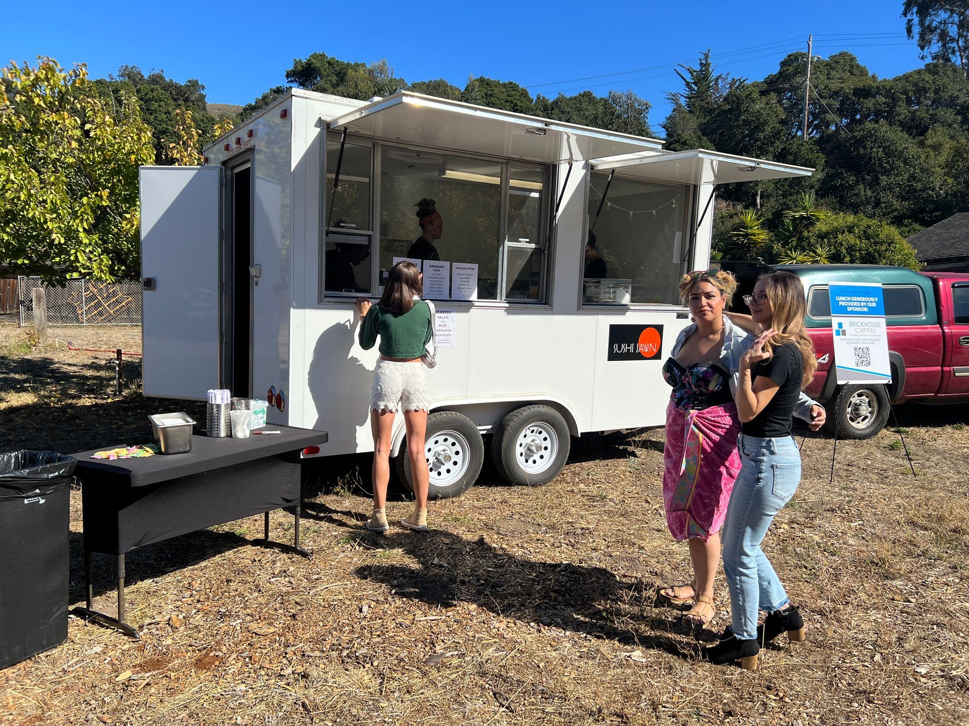 a group of women are standing in front of a food truck at an event in California called the cryo ranch 