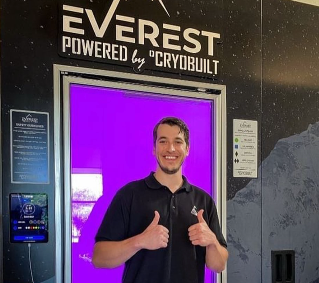 a man is giving a thumbs up in front of an everest powered by cryobuilt machine