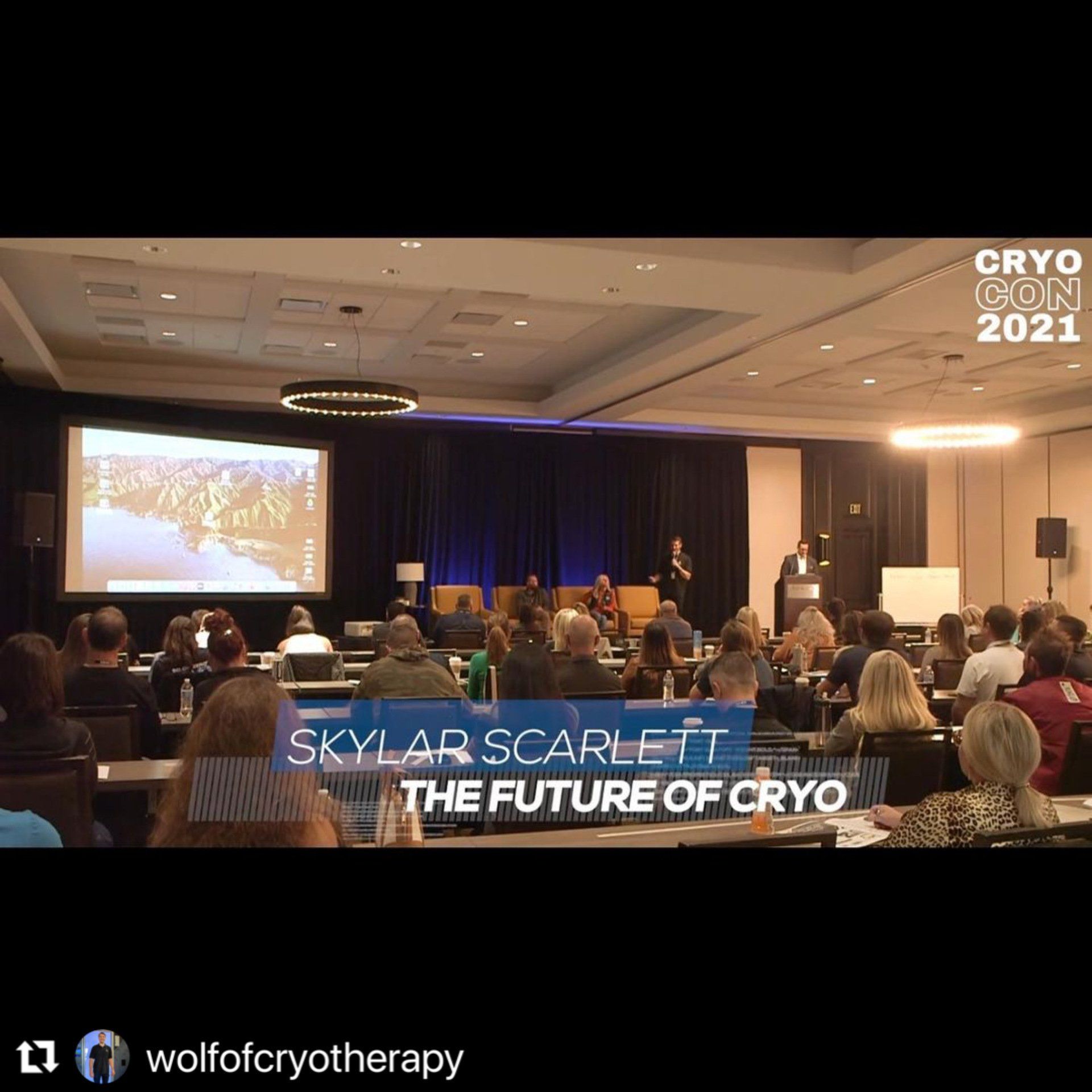 a group of people are sitting in a conference room watching a presentation by cryo expert Skyler Scarlett