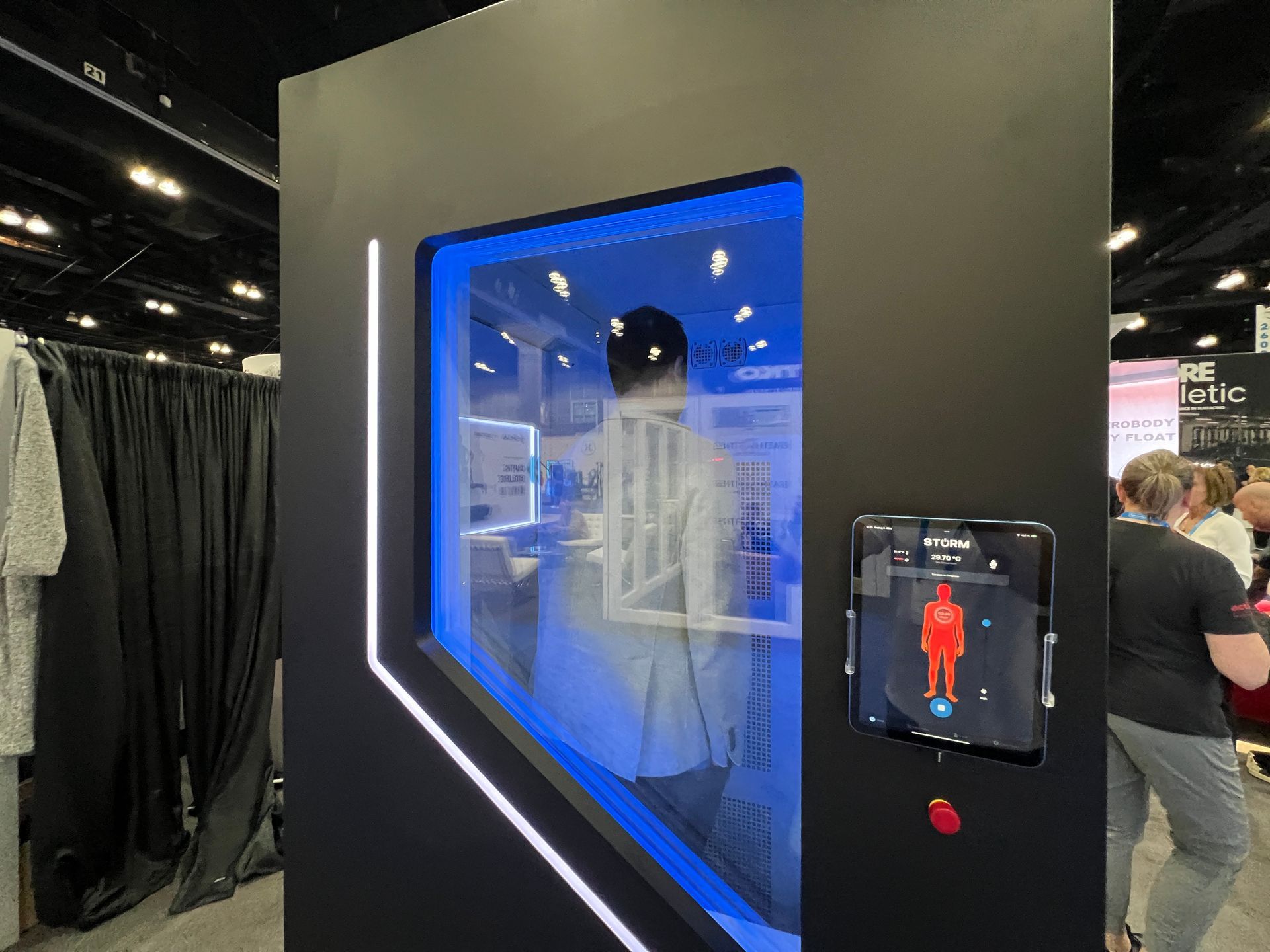 A woman is standing in front of a display of a 3d model of a person