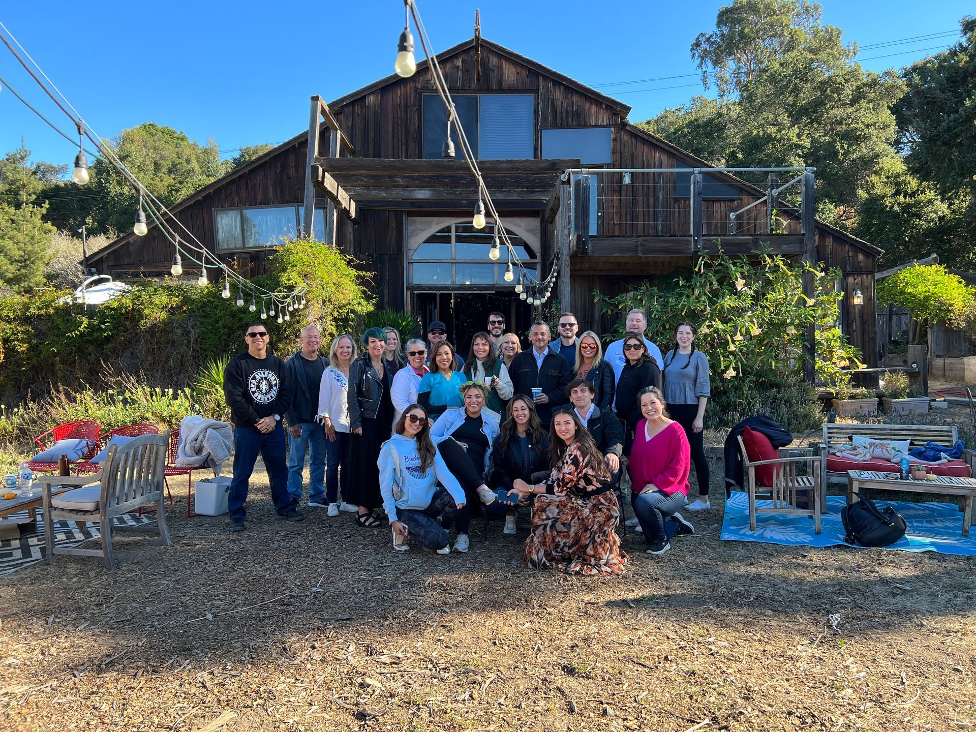 a group of people are posing for a picture in front of a wooden building at an event called the cryo ranch in California 