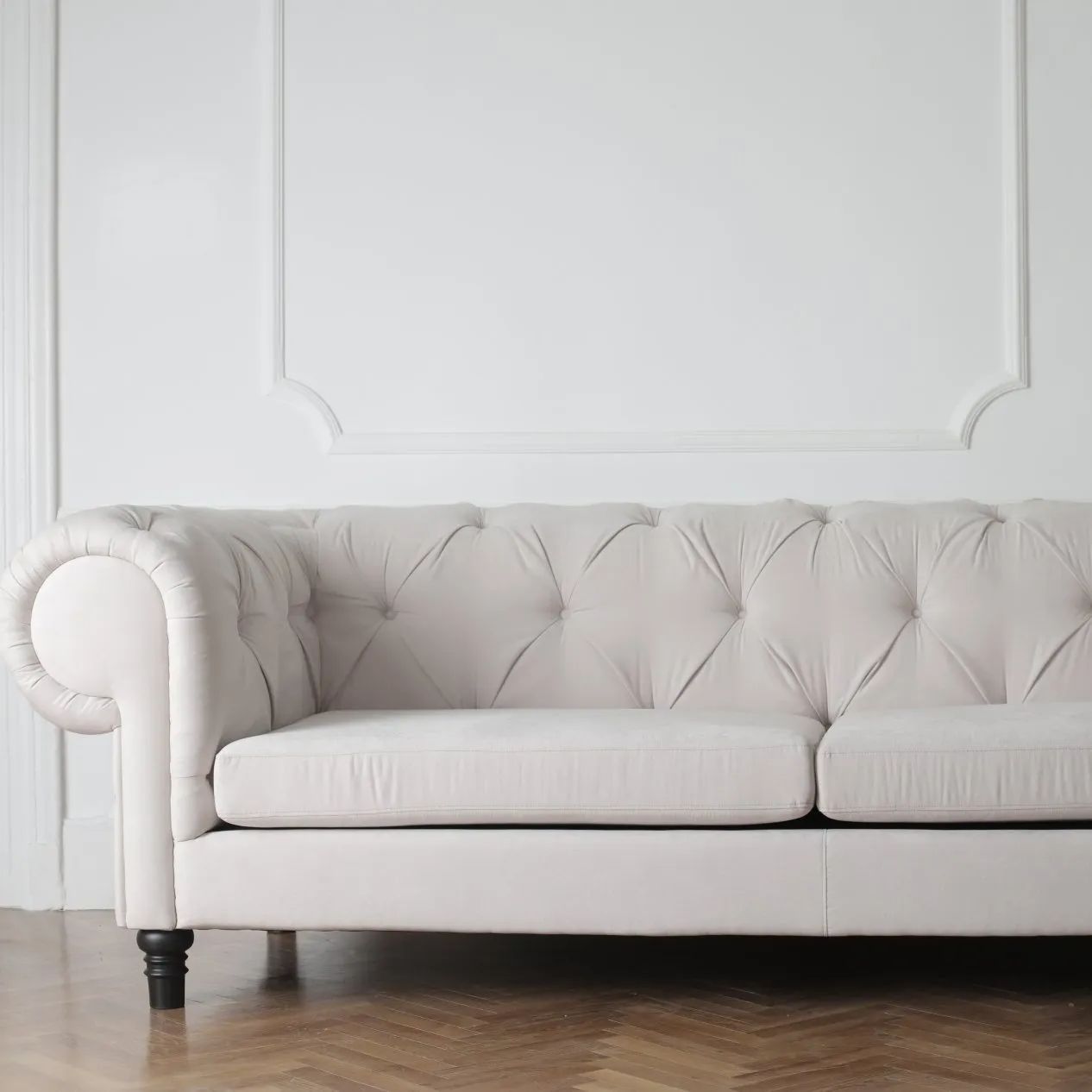 a cream colored, upholstered couch