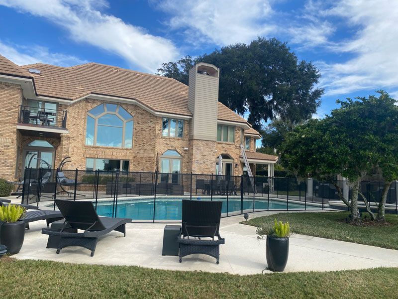 A large brick house with a swimming pool in the backyard.