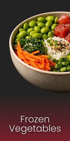 A bowl of poke featuring edamame, seaweed salad, shredded carrots, rice, and tuna, with