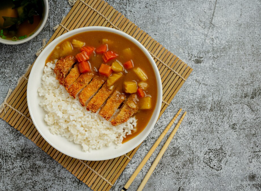 a close up of a piece of meat with chopsticks .