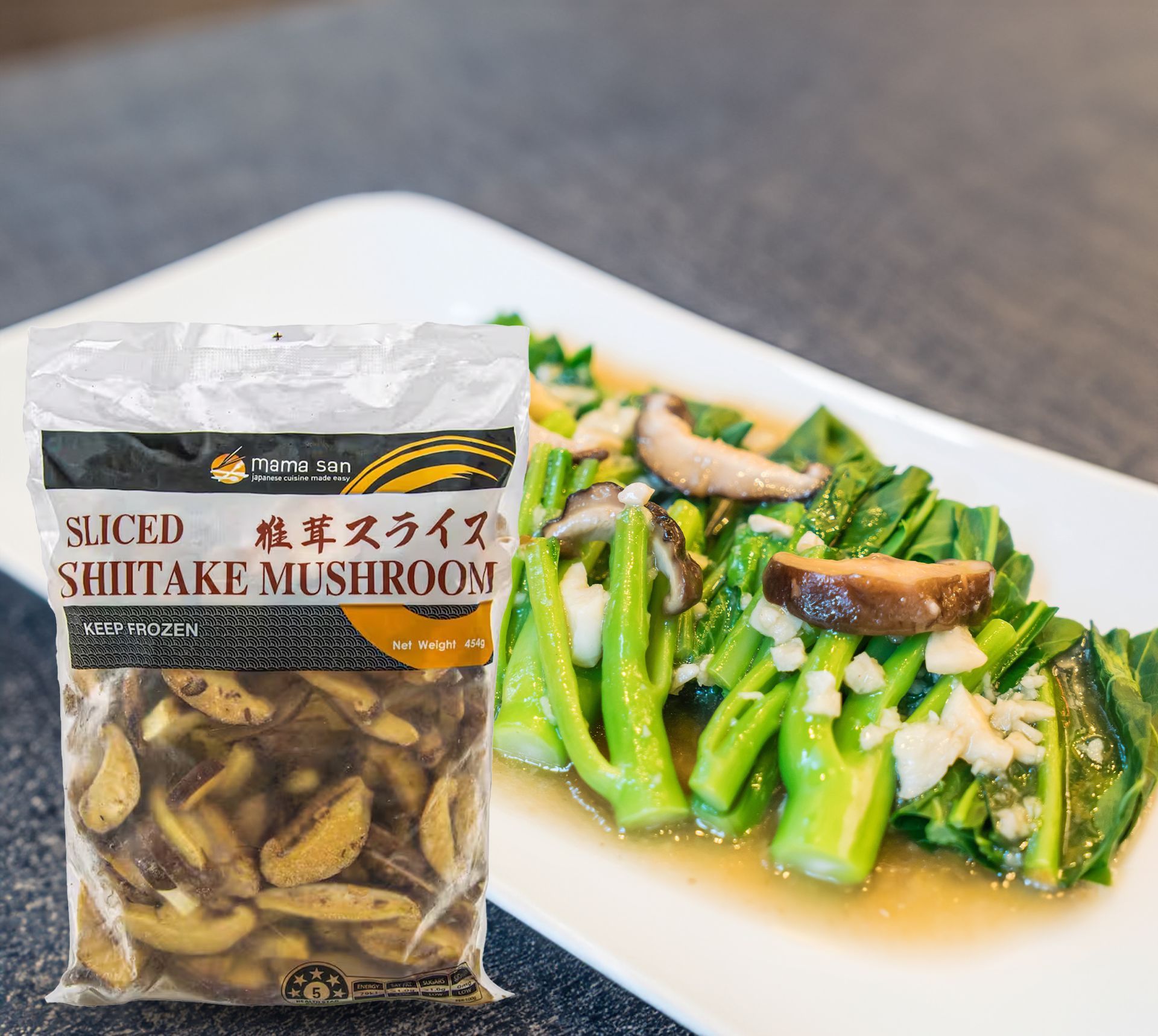 A bag of sliced shiitake mushrooms next to a plate of vegetables.
