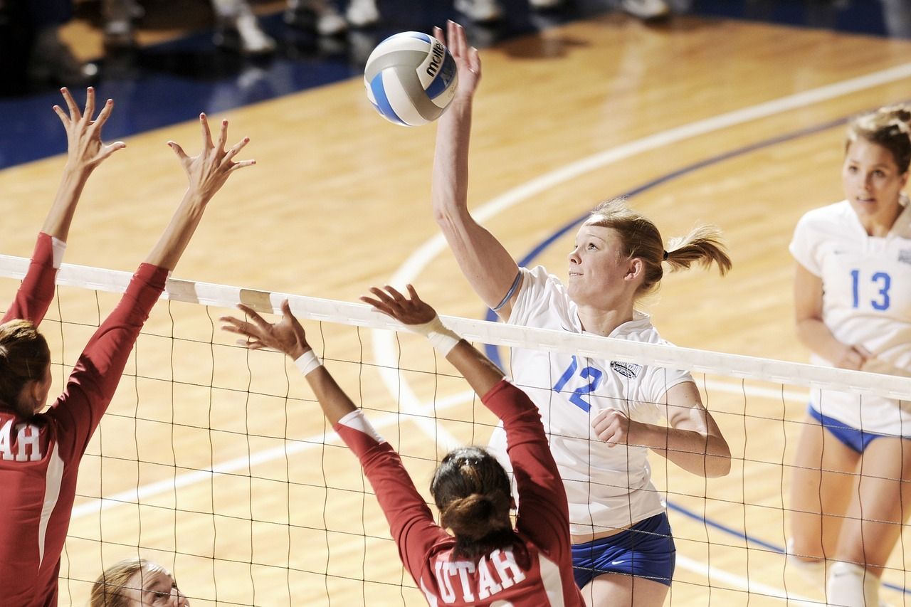 Women athletes playing volleyball