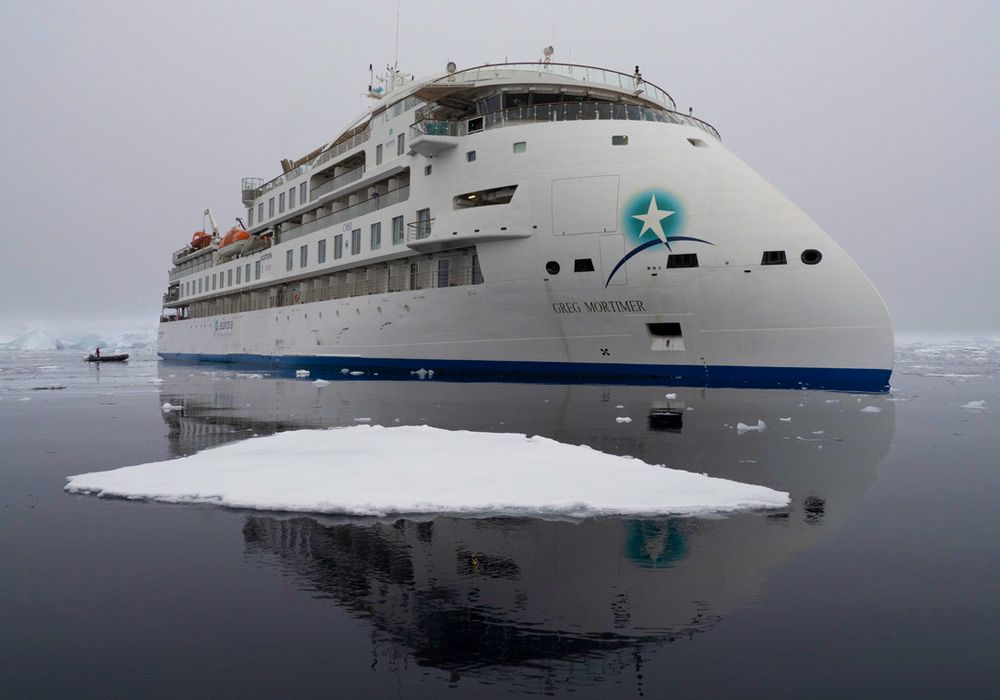 A large white ship with a star on the side is in the water