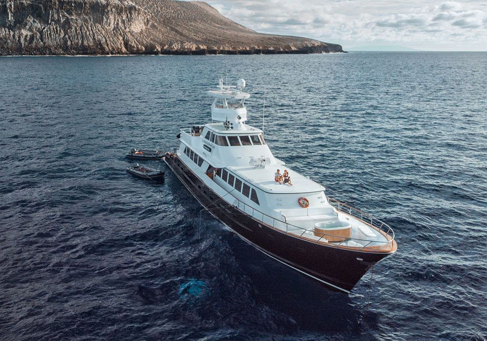 A large yacht is floating on top of a large body of water.