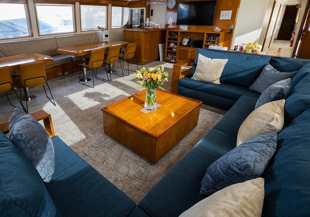A living room with blue couches and a wooden coffee table.