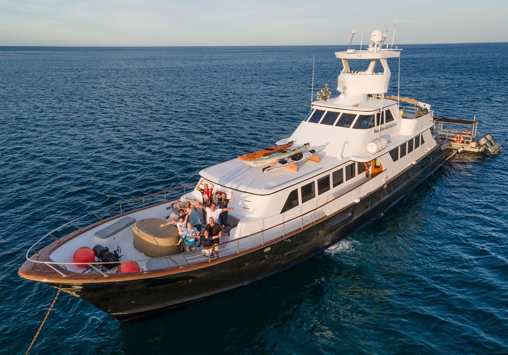 A large yacht is floating on top of a large body of water.