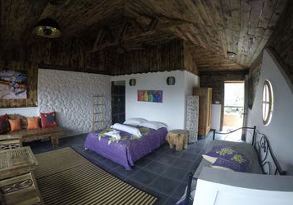 There is a large bed in the middle of the room in stone cottage