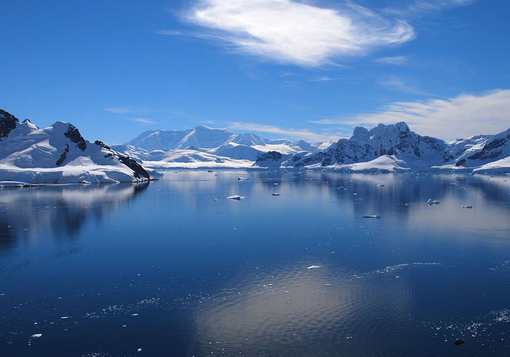 A large body of water with mountains in the background
