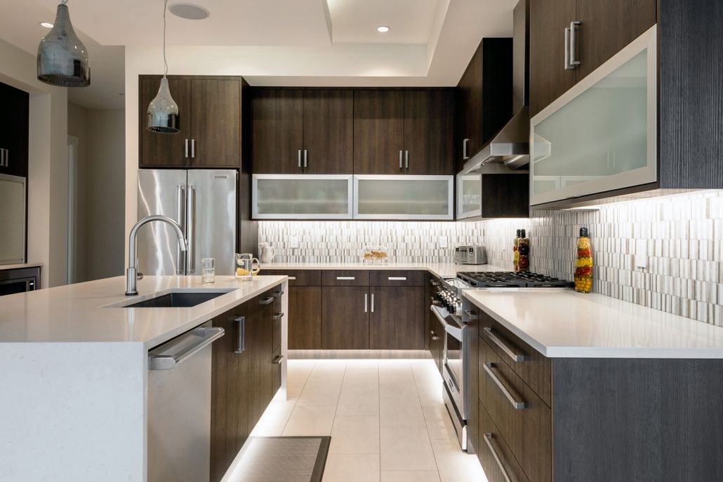 A kitchen with stainless steel appliances and wooden cabinets.