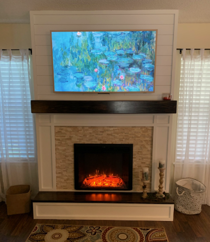 television set mounted over a warm and cozy fireplace