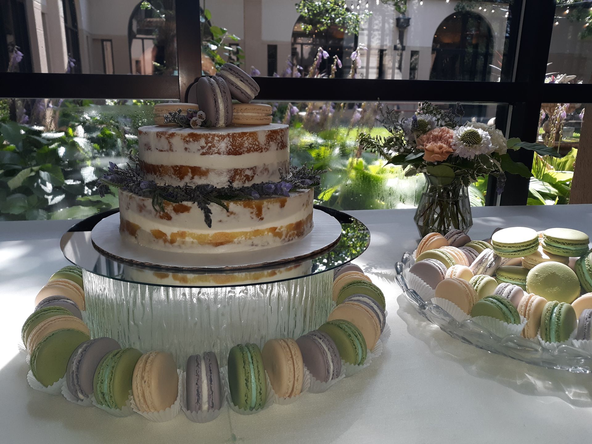 A table with a cake and macarons on it