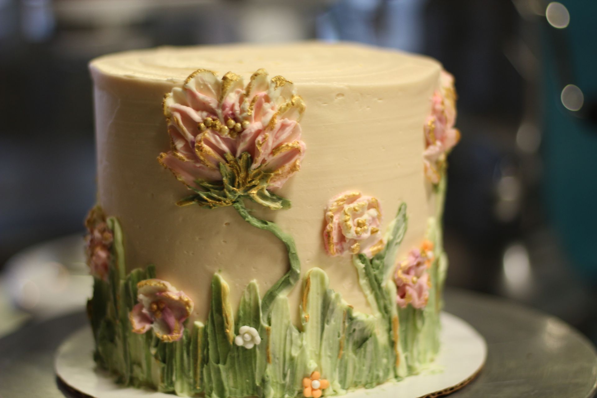 A cake with flowers on it is sitting on a table.