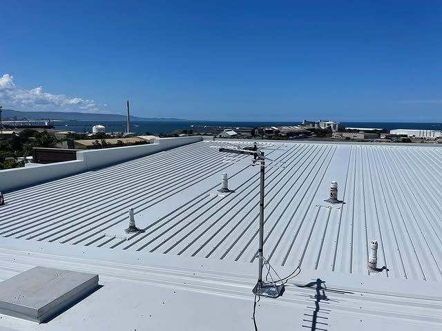 A White Roof With A Satellite Dish On It And A View Of The Ocean — Elevated Roofing Systems Pty Ltd In Barrack Heights, NSW