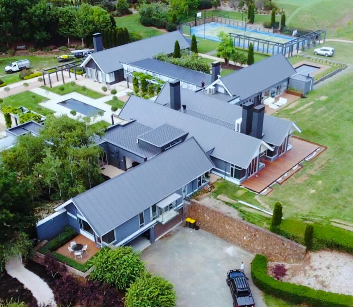 An Aerial View Of A House Under Construction With A Black Roof — Elevated Roofing Systems Pty Ltd In Barrack Heights, NSW