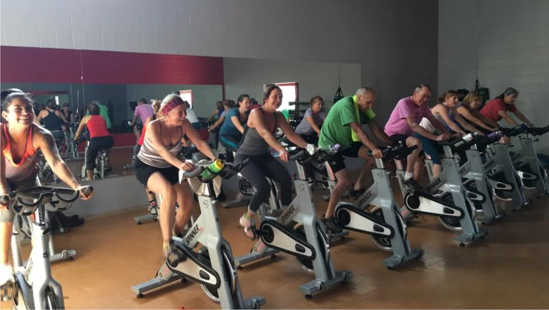 People on stationary bikes enjoying a spin class at High Altitude Health and Fitness in Taos, NM.