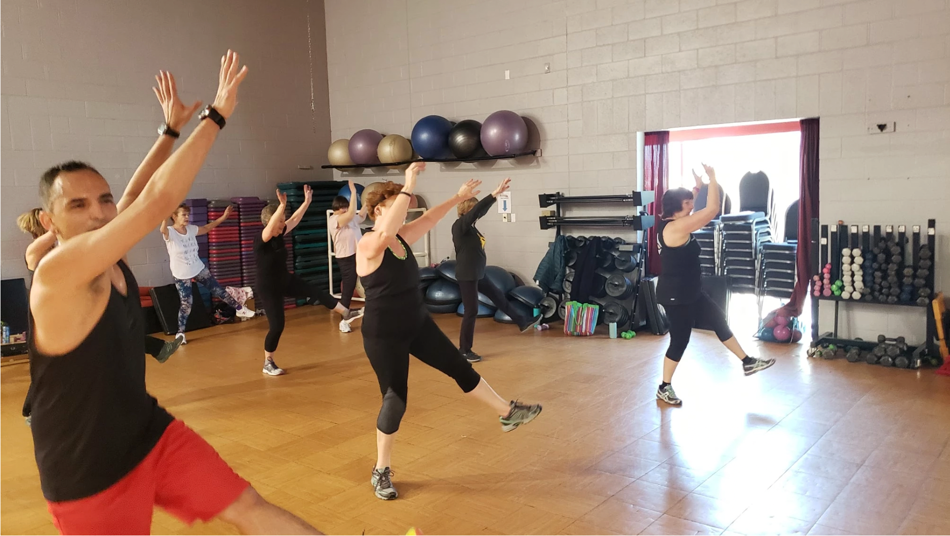 People participating in a fitness dance class at High Altitude Health and Fitness.