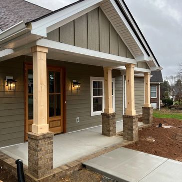 A house with a porch and a brick walkway