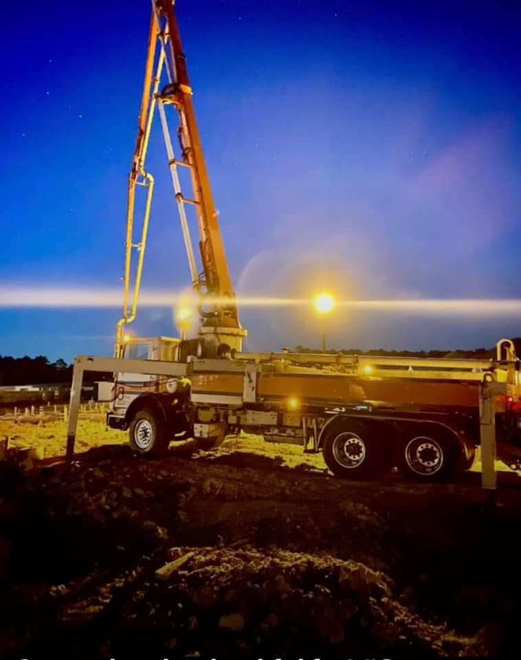 A concrete pump is being used to pour concrete on a bridge under construction.