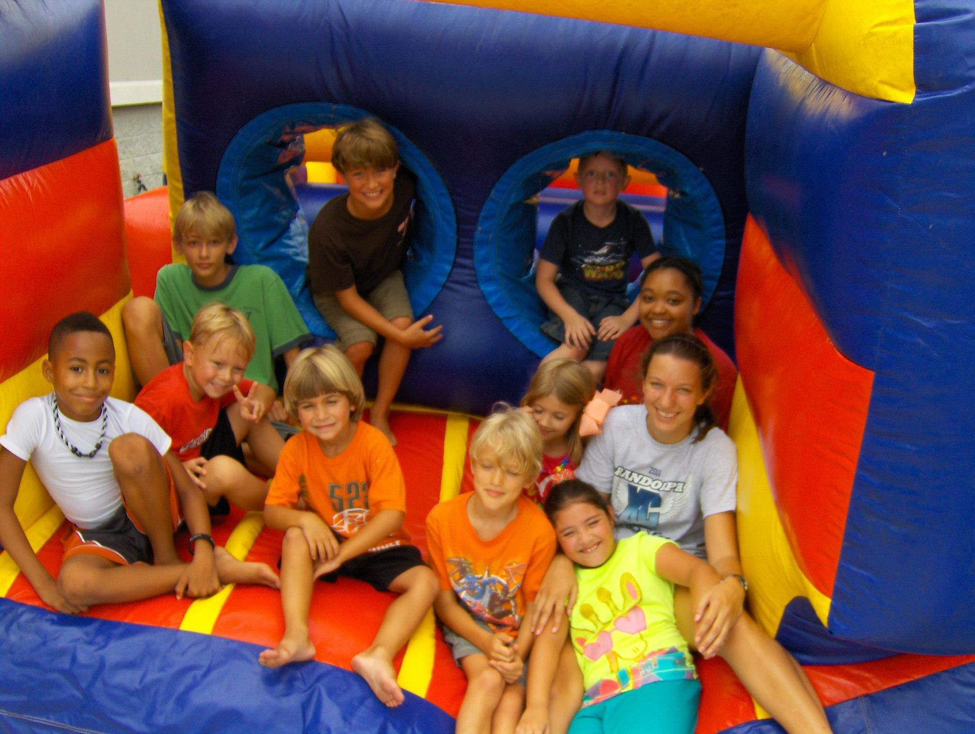 a group of children are sitting in a bouncy house