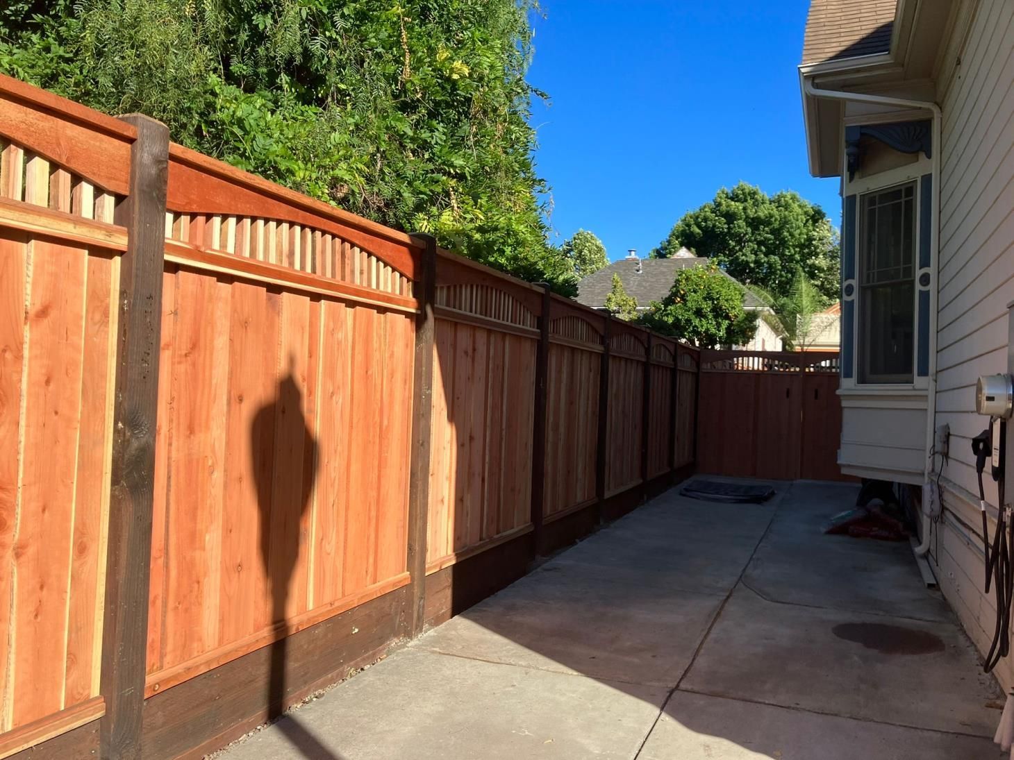 Wooden fence surrounding outdoor landscape, providing security and privacy.