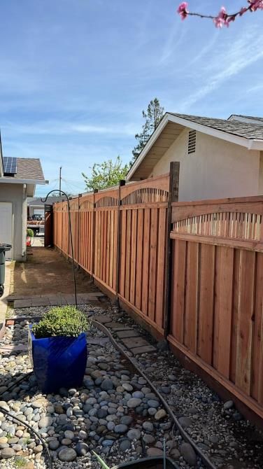 An elegant black aluminum fence with ornate finials, providing a sophisticated and durable boundary.