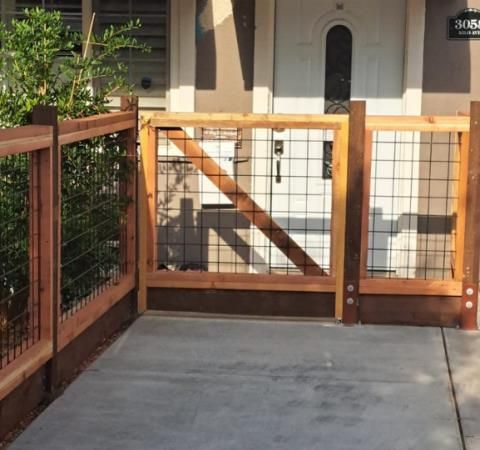 A silver metal barrier fence temporarily separates the area, creating a boundary between spaces.