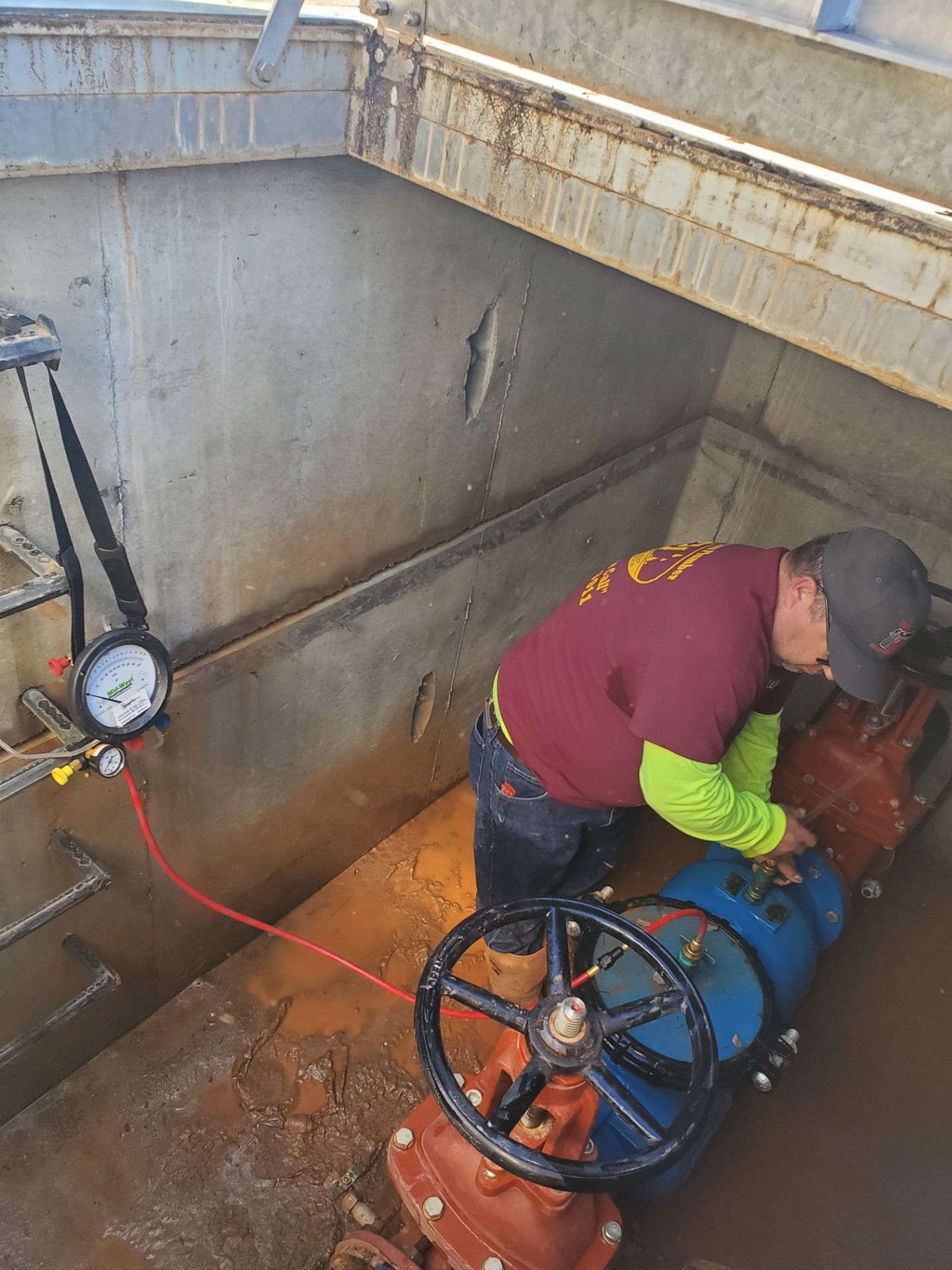 a plumber working on large water pipes