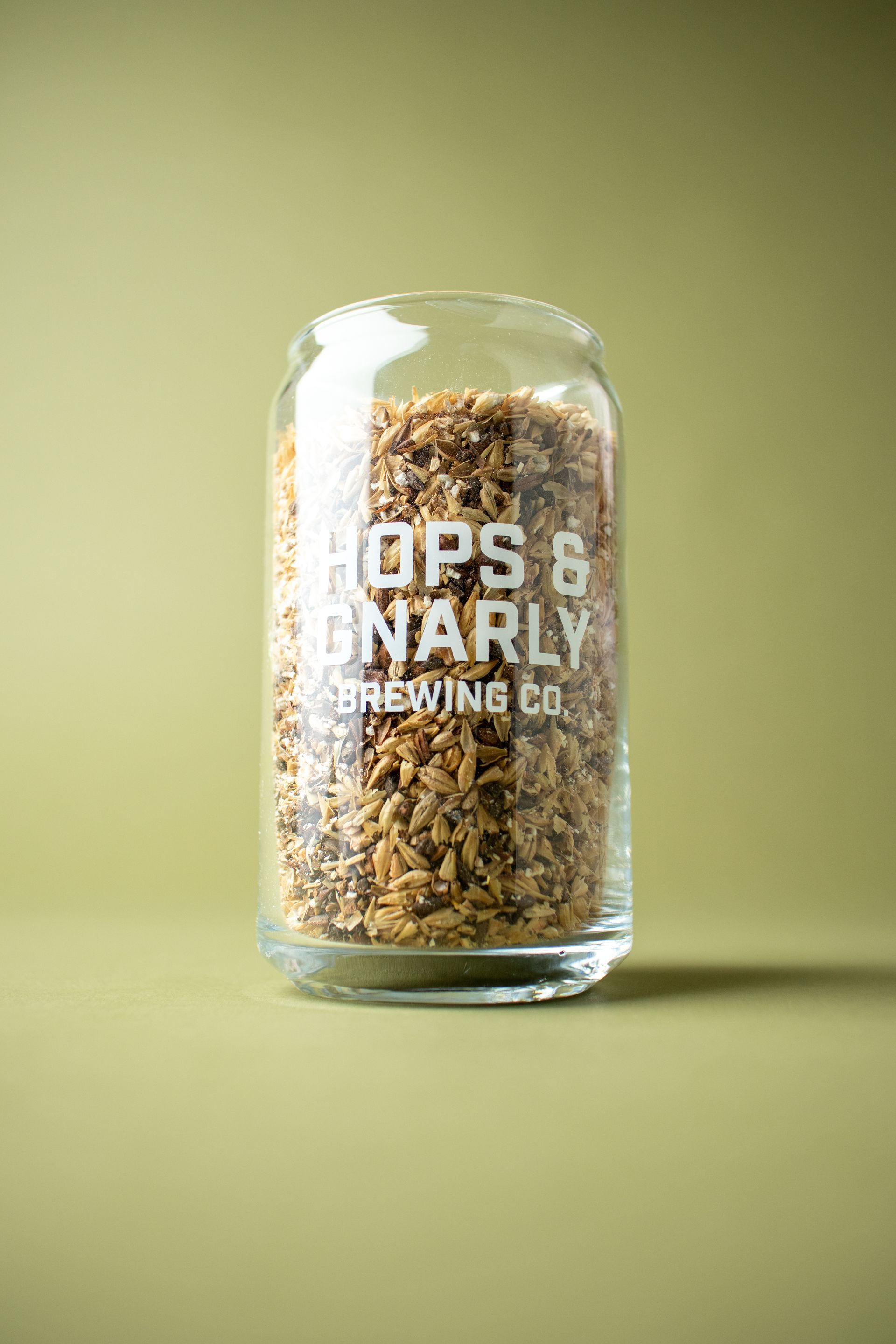 Hops & Gnarly Glass full of brewing grains