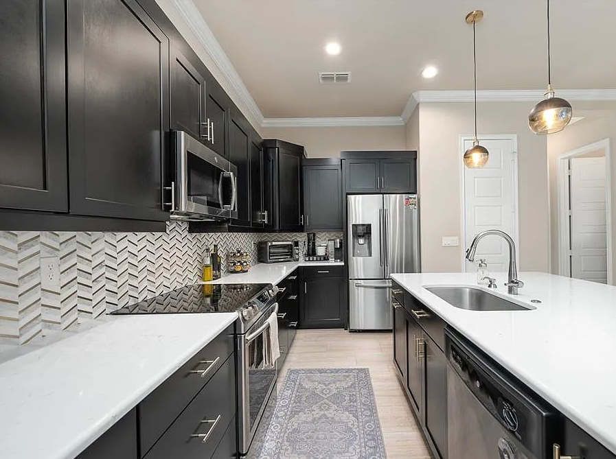 Spacious, newly finished garage with epoxy flooring and beige walls.
