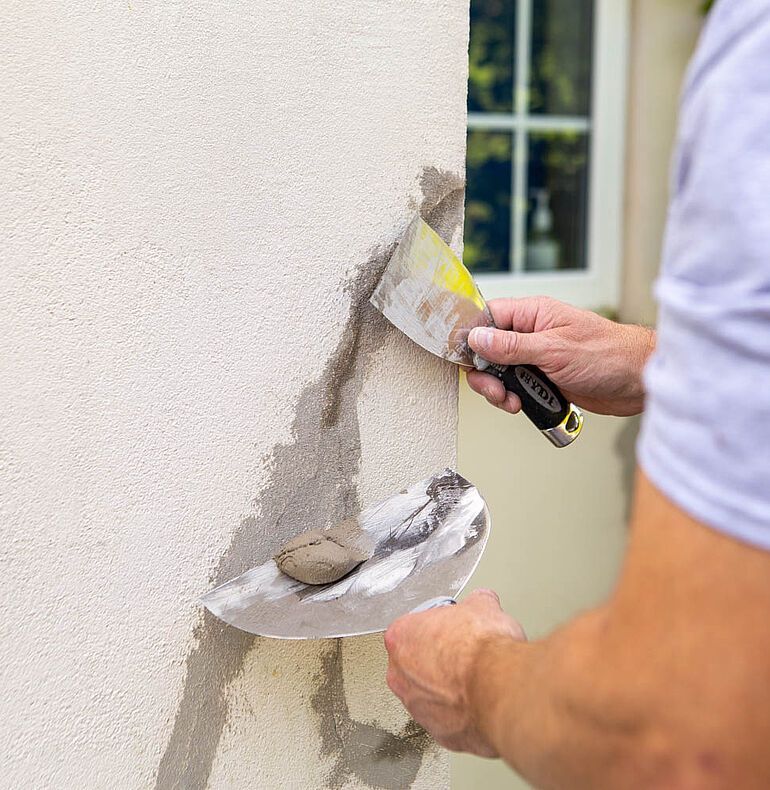 Light gray concrete floor in an empty room, with black trim and a window.