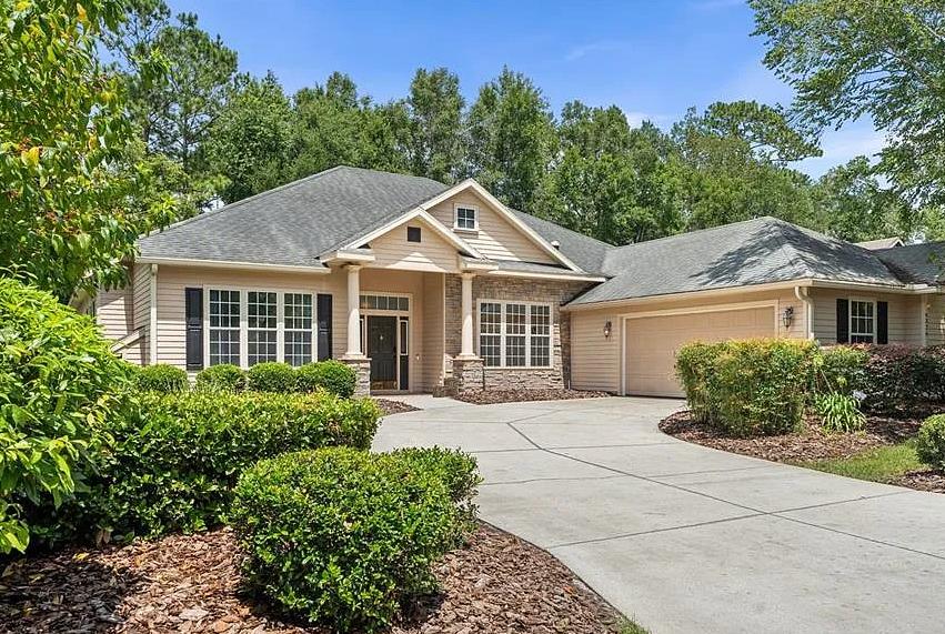 Spacious, newly finished garage with epoxy flooring and beige walls.