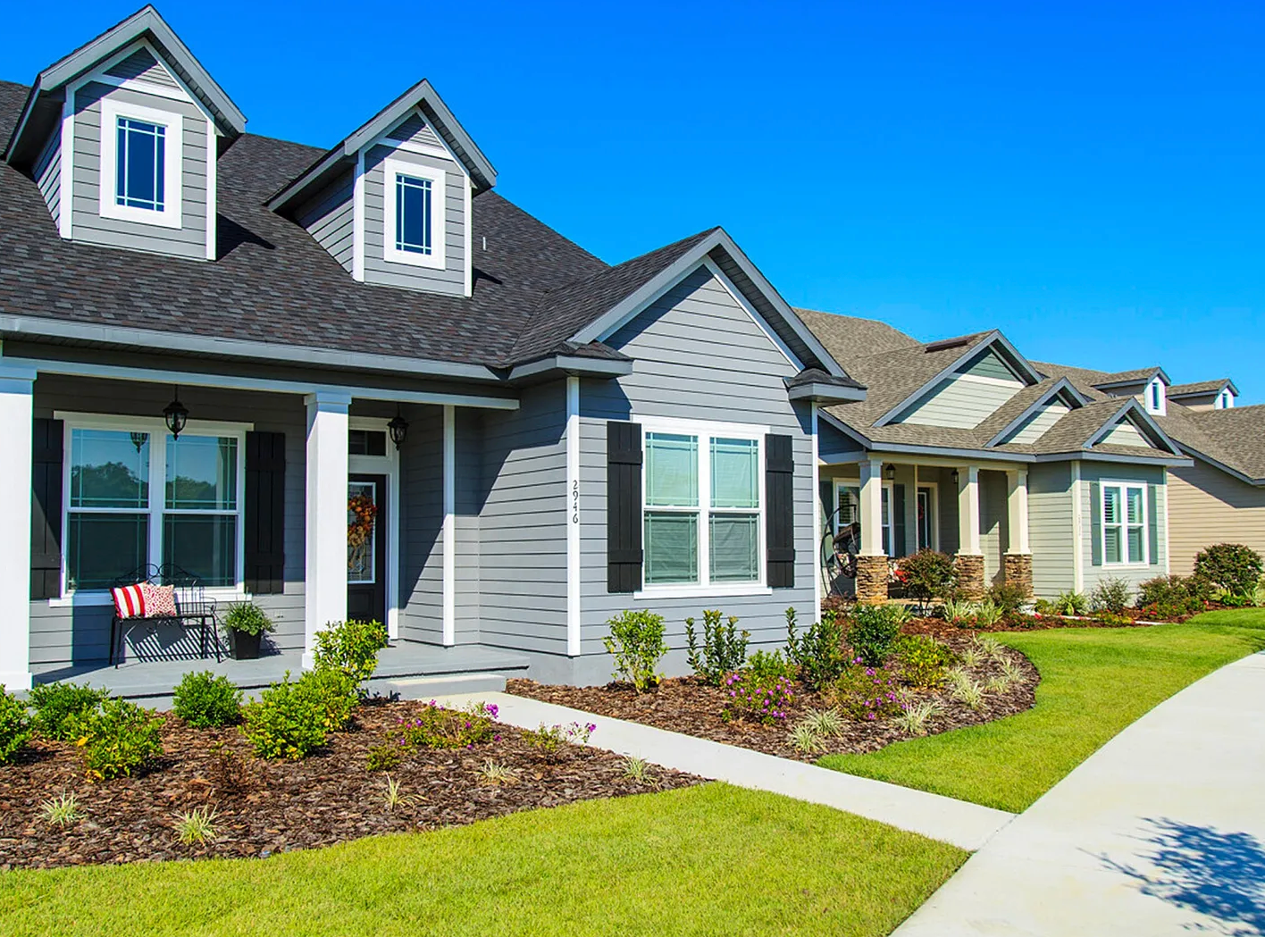 Spacious, newly finished garage with epoxy flooring and beige walls.