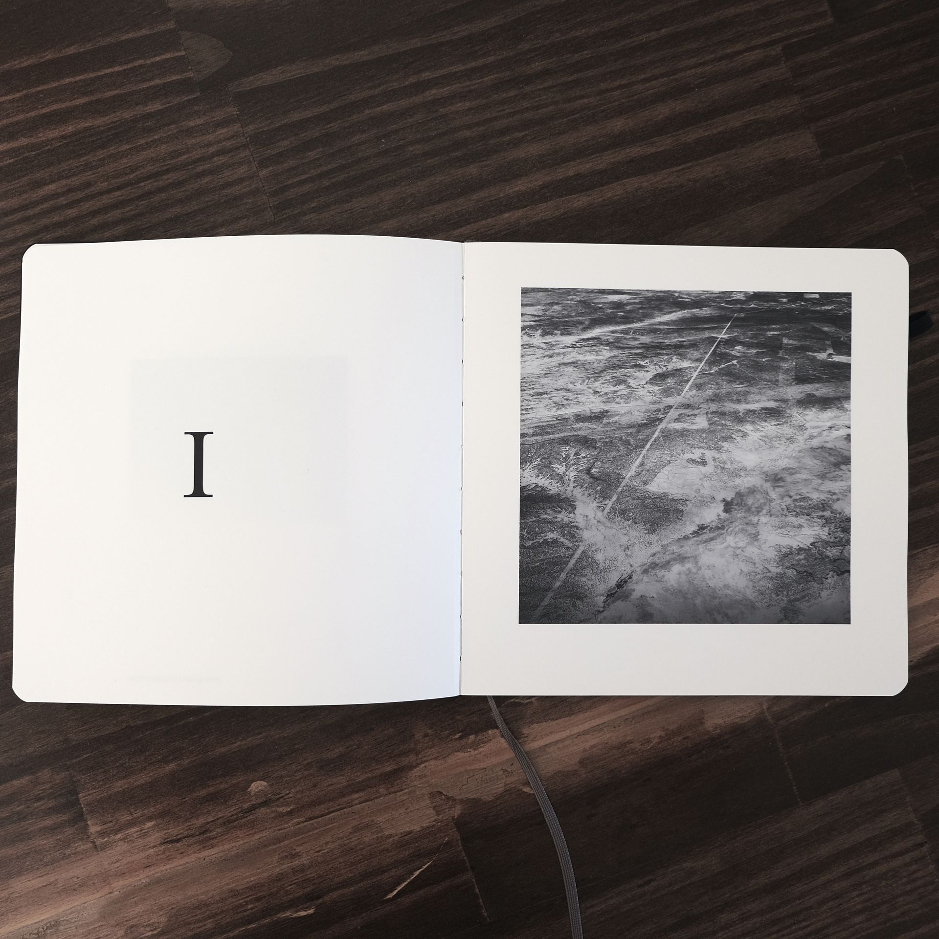 A book is open to a page with the letter i on it