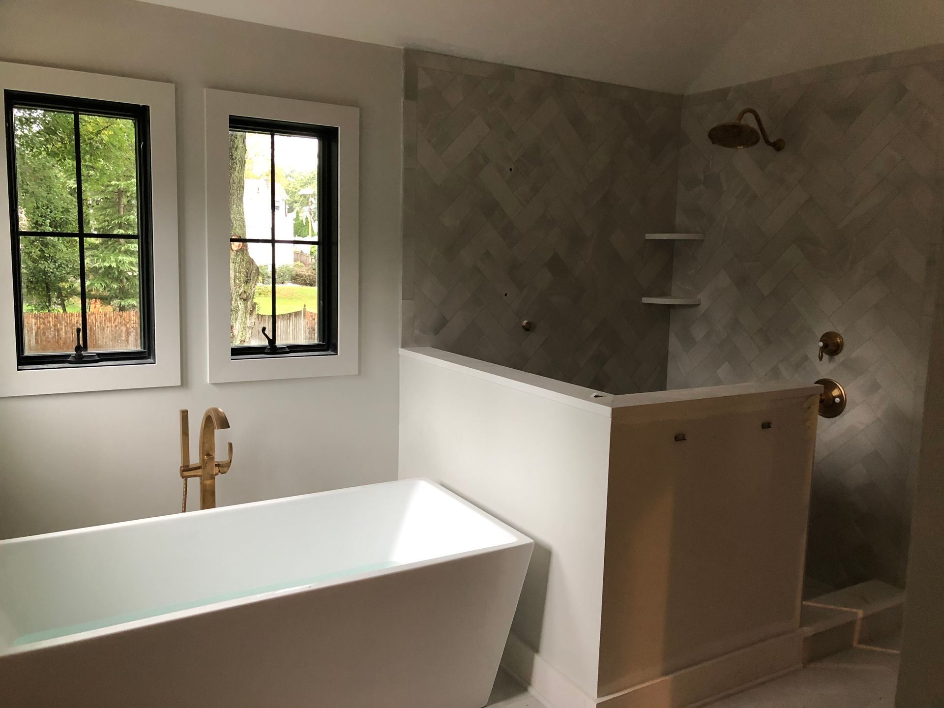 A bathroom with a bathtub and a shower.