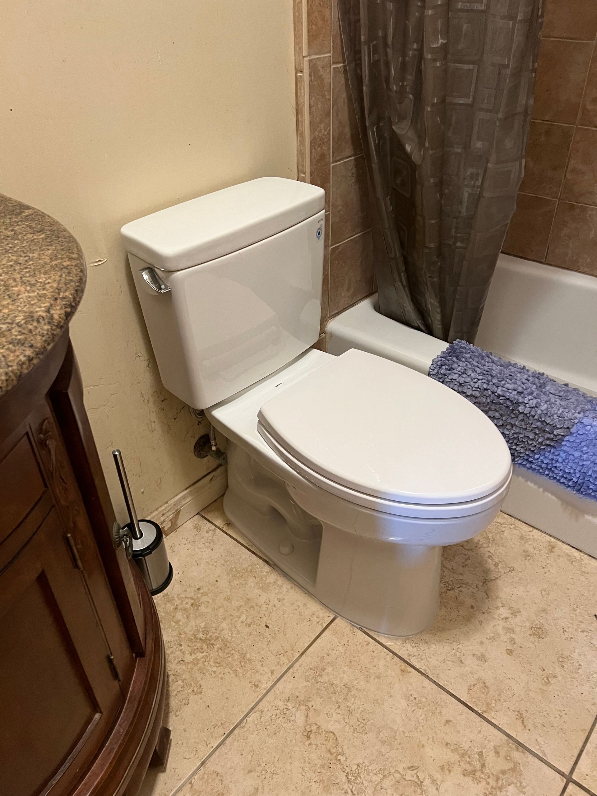 A bathroom with a toilet , sink , and bathtub.