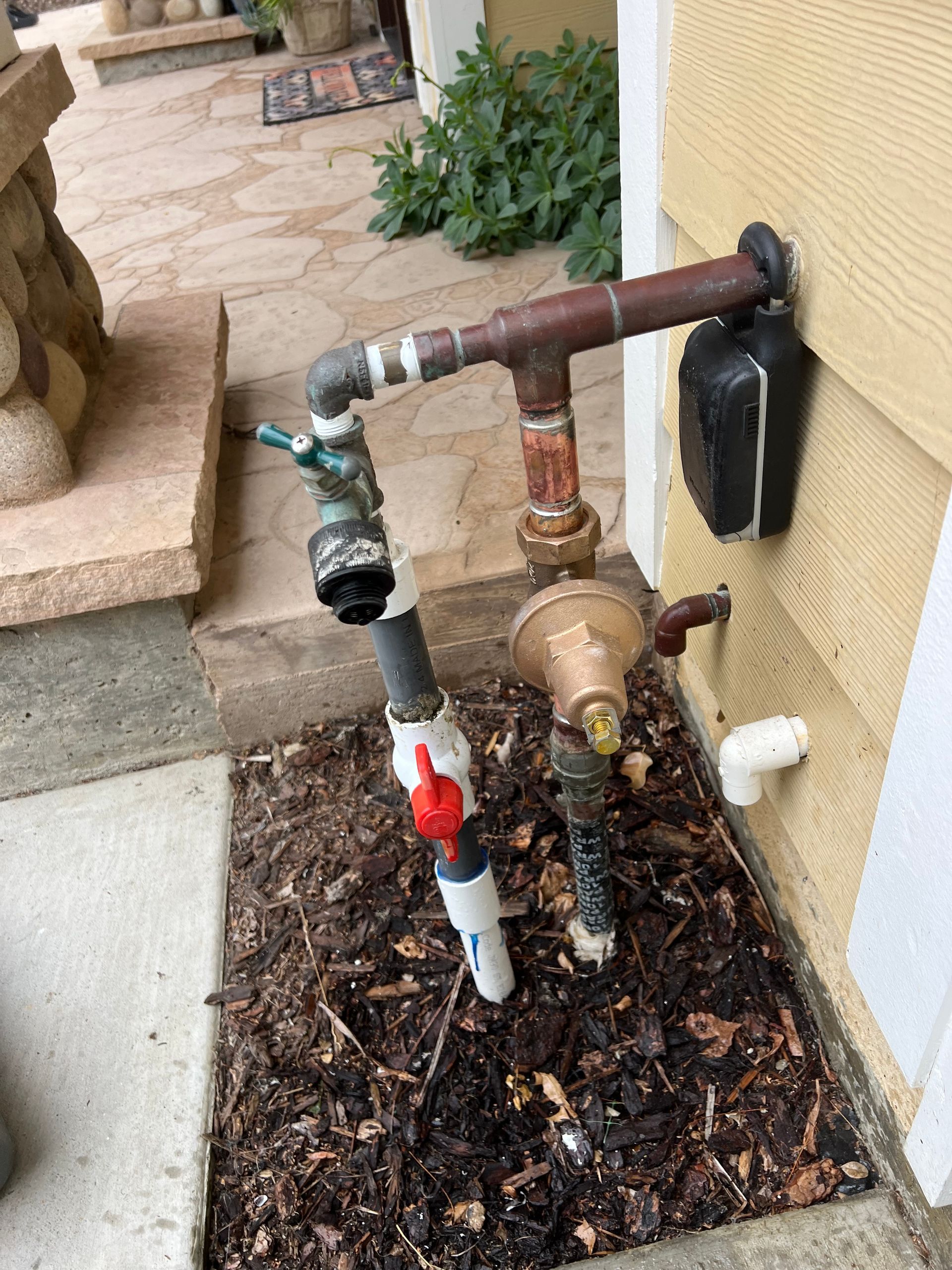 A hose is attached to the side of a house.