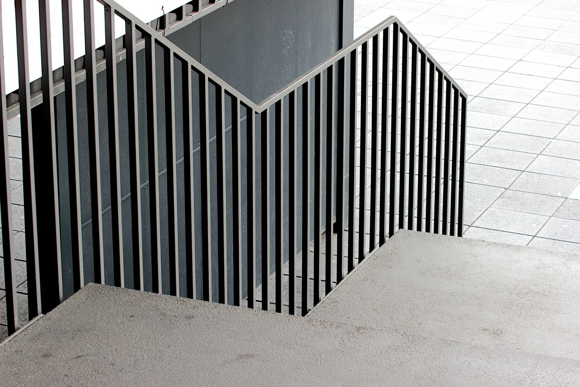 Gray concrete staircase with metal railing.