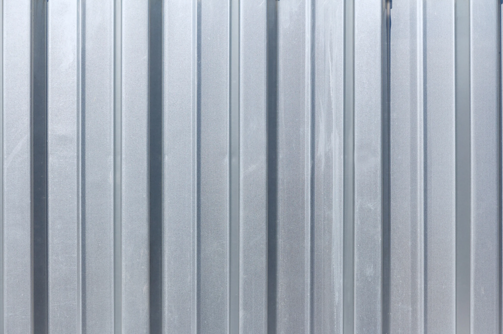 Vertical, corrugated metal siding in shades of gray.