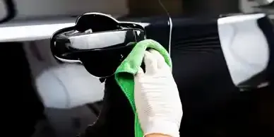A Person Is Cleaning The Door Handle Of A Car With A Green Cloth - Olympia, WA - Mobile Detailing By Mike