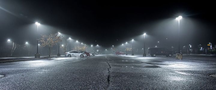 parking lot at night with street lights on