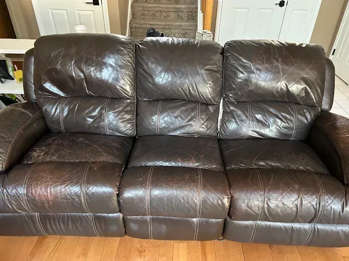 Brown leather reclining sofa in a living room.