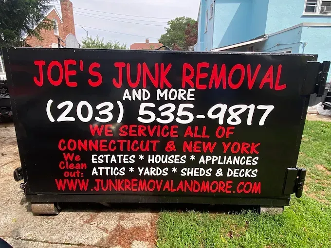 Black dumpster with red and white text: